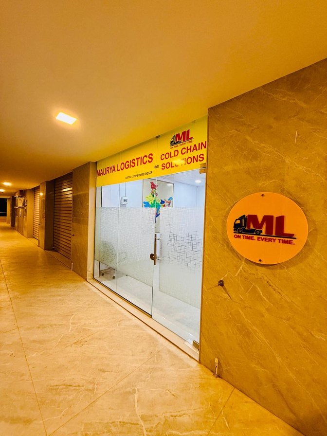 Corridor leading to the Maurya Logistics office entrance and ML roundel